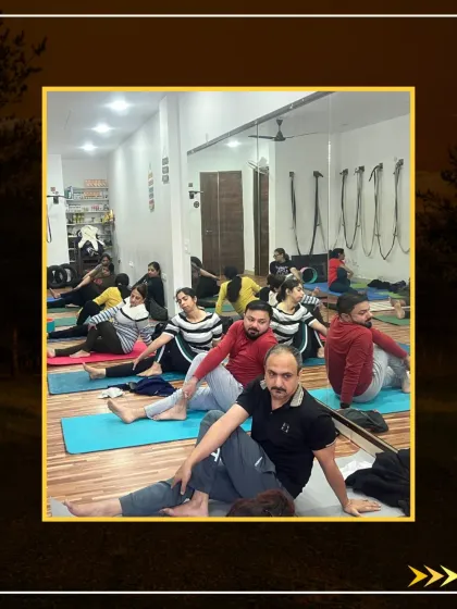 A large class enjoying the benefits of Vakrasana, which helps to release stress and back pain.