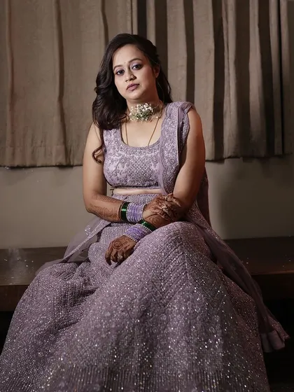 A beautiful bride in a lavender lehenga for her reception. The makeup is soft and shimmery.