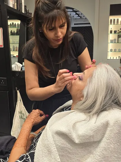 The process of creating this bridal cocktail magic. Here, I am carefully applying eye makeup to enhance her features.