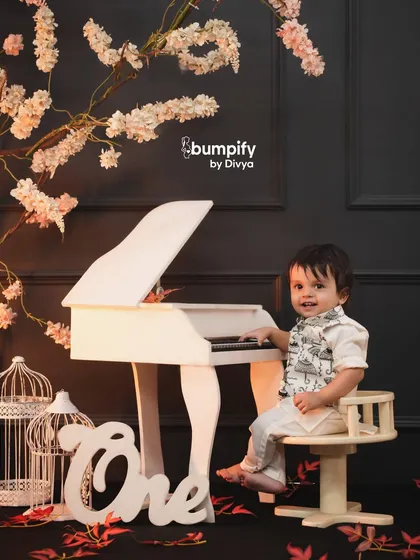 Let's celebrate your little one's first year with a creative theme. This mini maestro setup with a tiny piano and elegant decor is a unique way to mark the occasion and create truly memorable first birthday photos.