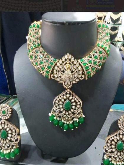 A stunning green and AD peacock-themed necklace set, beautifully displayed on a mannequin in my store.