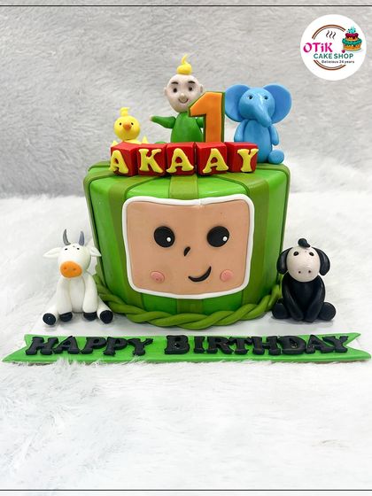 This Cocomelon-themed cake is perfect for a first birthday. We used fondant to create a cake shaped like the iconic watermelon TV, complete with edible figures of JJ and his animal friends.