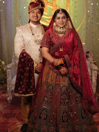 The complete royal look. This couple looks magnificent, with the bride in a heavy velvet lehenga and the groom in a coordinated embroidered sherwani.