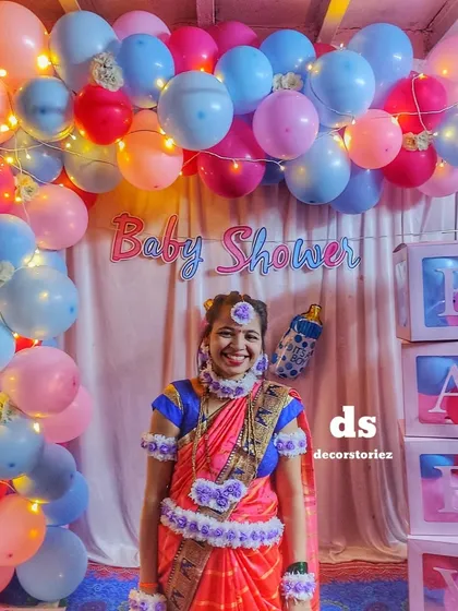 Capturing the joy of a traditional Dohale Jevan or baby shower. I blend cultural elements with modern decor, like this beautiful balloon arch with integrated fairy lights, creating the perfect backdrop for the happy mom-to-be.