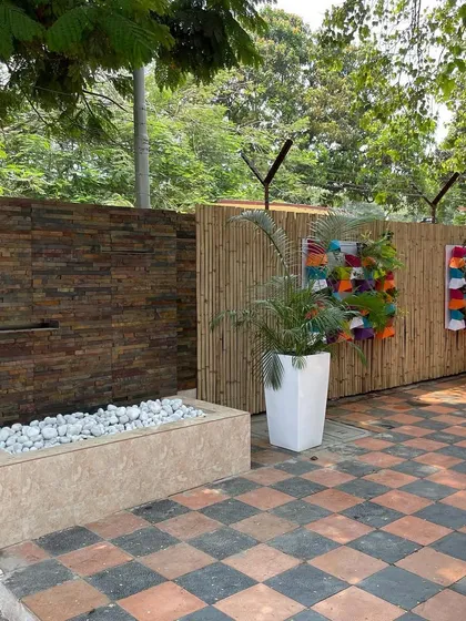 We installed a custom water feature with a stone-clad wall and a bamboo screen as part of the INS Tanaji project. This adds a soothing auditory element and a modern touch to the outdoor space.