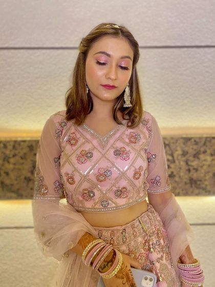 Another shot of the client, showing her complete look with soft curls and delicate jewelry, perfect for a wedding guest.