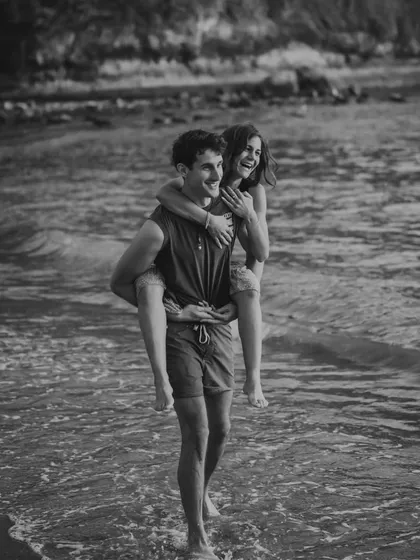 A playful piggyback ride through the waves in Bali, captured in a timeless black and white. This photo is full of movement, joy, and the spirit of adventure.