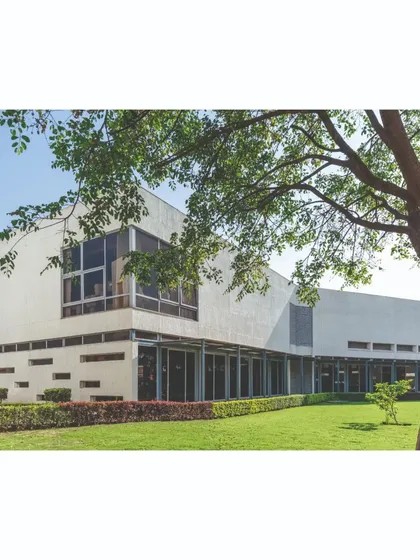 The main office block at the Ajax campus is designed with large glass facades to maximize natural light. The building is set within a lush green lawn, and the master plan ensures that green spaces are interspersed between all built forms.