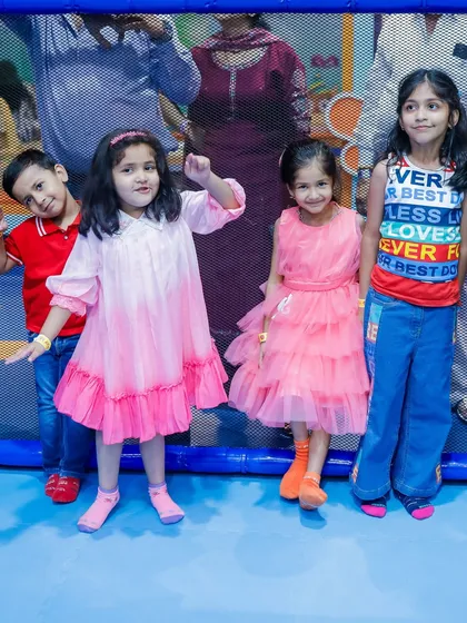 Kids posing for a photo inside the play area. Our zones are clean, well-lit, and provide a great backdrop for memorable pictures.