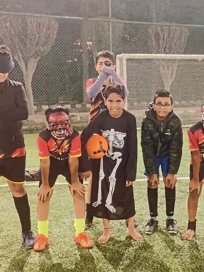 The whole squad getting into the Halloween spirit with spooky masks and costumes.