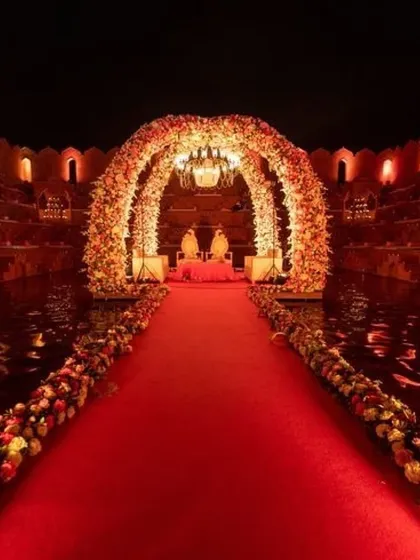 The same royal venue transformed for a night ceremony. With dramatic lighting and the reflection on the water, the entire space takes on a romantic and majestic feel.