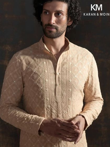 A closer look at the ivory shadow kurta, focusing on the intricate tone-on-tone hand embroidery. This is where handwork meets sculpted precision, crafted for the gentleman who values tradition with quiet luxury.