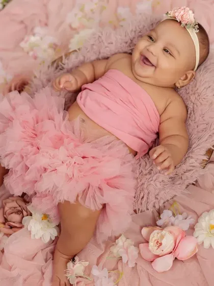The giggles and chubby rolls of a four-month-old are just the best. This milestone session is all about capturing your baby's budding personality and infectious laughter in a beautiful, fun setup.