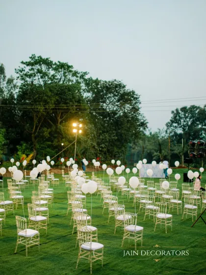A field of dreams for a wedding ceremony. I arranged the guest seating on a lush green lawn, with each chair holding a white balloon, creating a simple yet whimsical and highly photographic setting.
