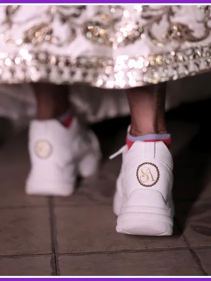 A close-up of the custom wedding sneakers with the couple's initials. A cool, comfortable, and personalized detail.
