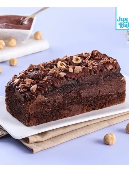 Our Ferrero Nutella Teacake is a bestseller for a reason! It's a rich chocolate cake loaded with Nutella, Ferrero Rocher, and hazelnuts.