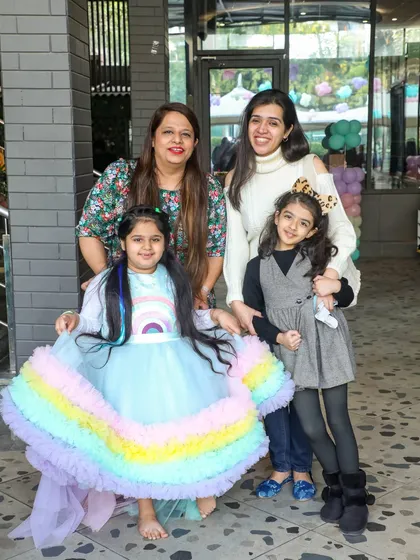Friends and family gather for a photo at the entrance of the Little Pony party, ready for a magical day.