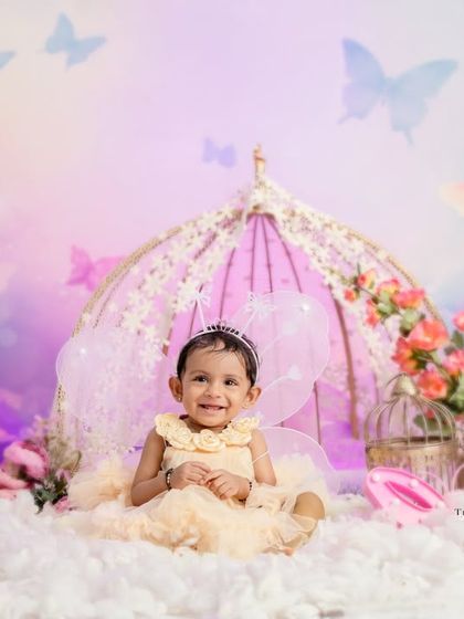 A sweet portrait of the birthday girl wearing a tiara, ready for her butterfly-themed celebration.