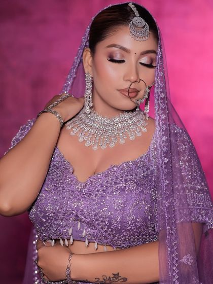 A modern bridal look featuring a lavender lehenga paired with a stunning diamond and silver jewellery set. This shows how you can rent contemporary jewellery for a unique look.