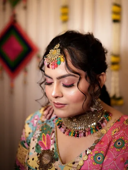 A beautiful shot with eyes closed, showcasing the shimmering pink eyeshadow. This look is perfect for the bride who wants to embrace color on her Haldi day.