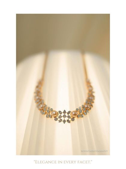 An elegant macro shot of a diamond necklace, photographed against a soft, glowing background to emphasize its sparkle.