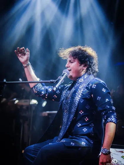 A classic shot of our lead vocalist, hand raised, connecting with the divine through music.