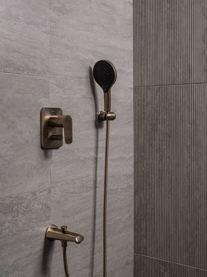 A close-up of the vintage-inspired shower fixtures in the guest bathroom, showcasing our attention to detail and material quality.