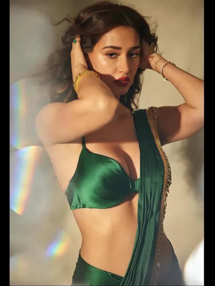 A close-up of the Diwali glam. The bold red lip and the soft, face-framing waves come together to create a stunning and festive look for Disha.