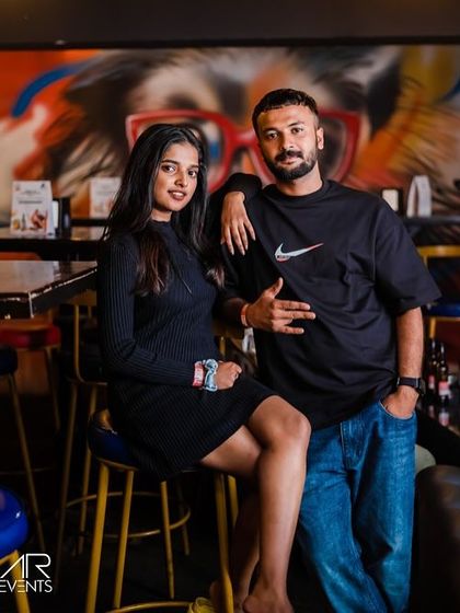 A couple posing for a photo near the bar.