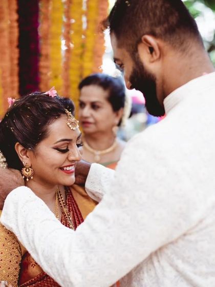 An intimate moment between the bride and groom. Her makeup is soft and romantic, with a focus on her smiling eyes.