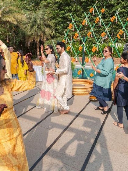 The joy of a Haldi ceremony is infectious. Here, the couple and their guests dance together, surrounded by our festive yellow-themed decor.