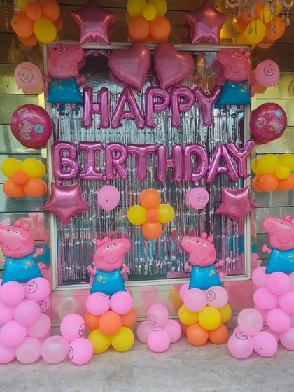 Another angle of the Peppa Pig themed birthday decoration, showing the full arrangement with multiple character balloons.