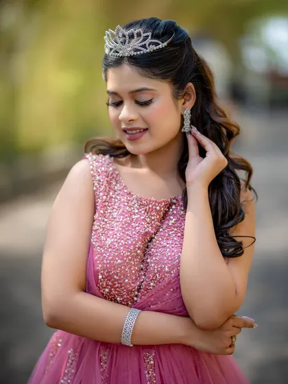 A close-up of the model's princess-like look, with a sparkling tiara and soft, romantic makeup.