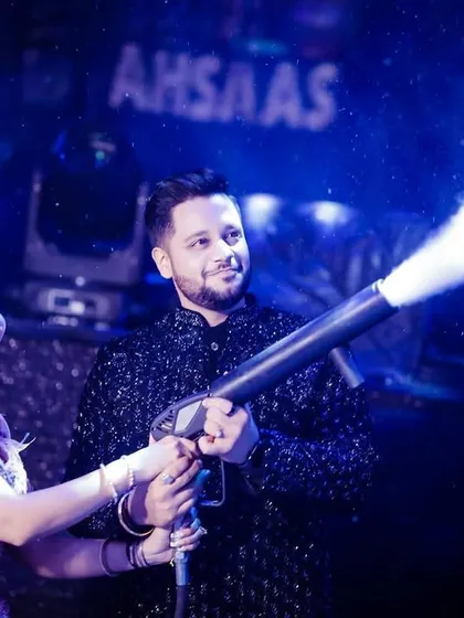 The couple shares a fun moment with the CO2 cannon, adding to the party's excitement.