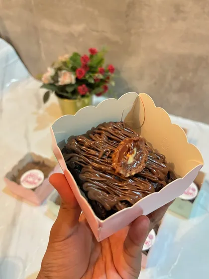 A close-up of one of my individual brownies. This one is drizzled with Nutella and topped with a Ferrero Rocher, making it an extra decadent treat.