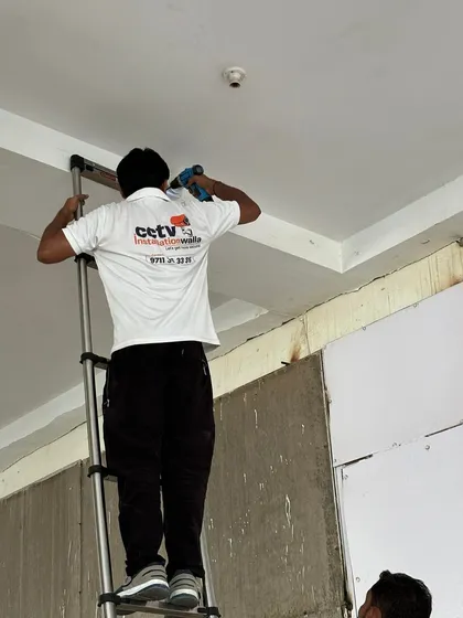 My technician is shown here carefully mounting a dome camera. We use professional tools and techniques to ensure every camera is securely fitted and positioned for the best possible viewing angle.