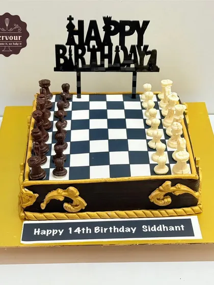 Checkmate! A chess theme cake for a 14th birthday. This cake features a complete, edible chessboard with chocolate chess pieces, all made with minimal fondant.