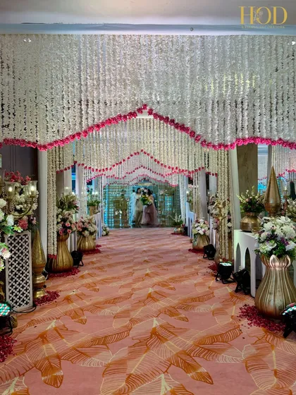 Imagine walking towards your forever through a hallway of blooms. I create romantic pathways like this one, with a ceiling of hanging white and pink floral strings, to make the journey to the aisle as beautiful as the destination.