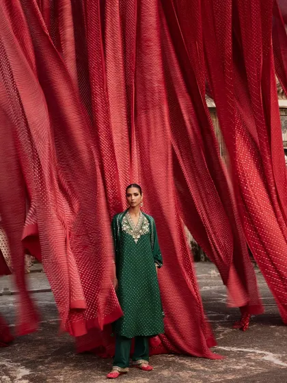 For this Anita Dongre campaign, I wanted to create a powerful visual ode to Indian craftsmanship. Here, a model stands in an emerald green ensemble against a backdrop of vibrant red Bandhani textiles, creating a striking contrast that celebrates the beauty of traditional tie-dye techniques from Rajasthan.