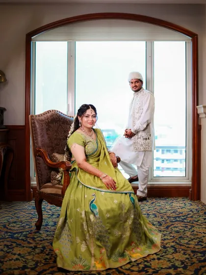 A regal portrait of the couple in their Mehendi outfits, looking poised and happy.