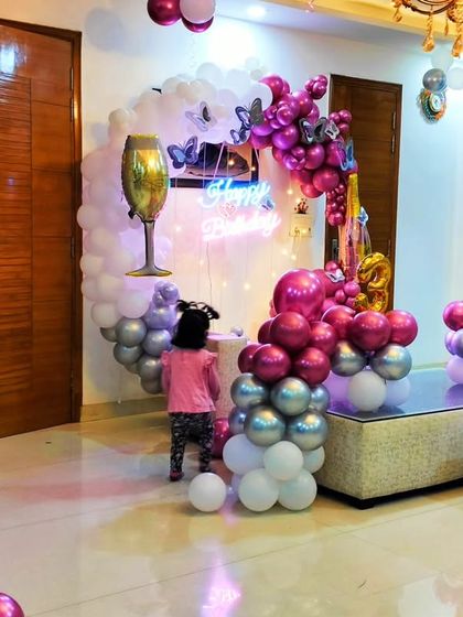 A child interacts with the 32nd birthday setup, showing that even elegant decorations can be fun for all ages.