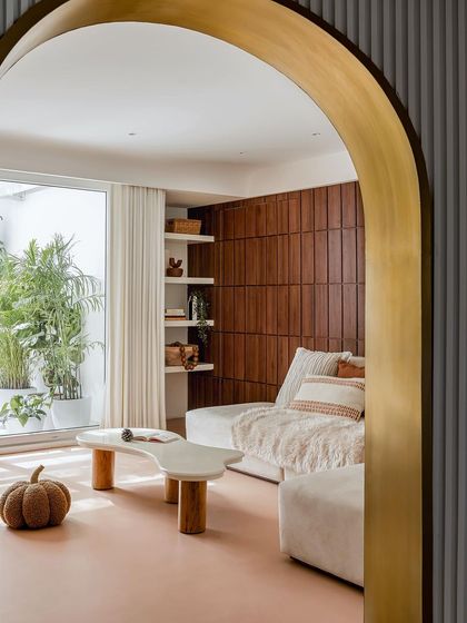 A view into the family lounge through a brass-lined arch, showcasing the cozy and inviting atmosphere.