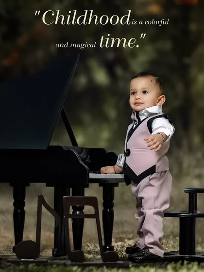 Childhood is a colorful and magical time. A boy in a stylish vest and suit stands proudly at his piano.