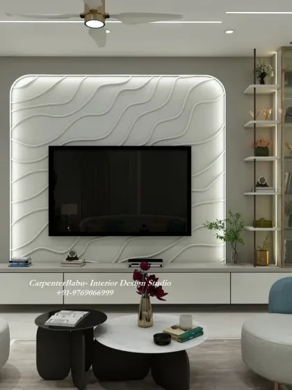 This TV unit features a unique wavy 3D panel, creating a sense of movement and artistry. The curved armchairs in blue add a soft, contrasting color to the room.