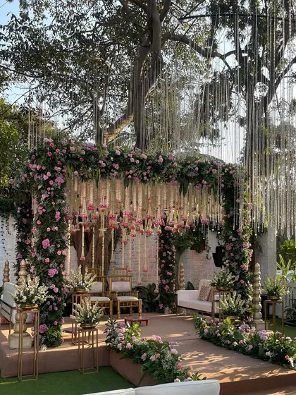 This traditional mandap is a vision in pastel pinks and whites. We used hanging floral arrangements and classic seating to create a space that feels both grand and intimately romantic.