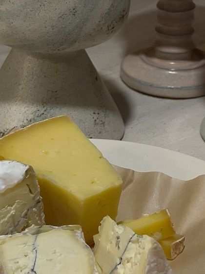 A cheese plate next to our custom goblets. The collection was designed to stimulate all the senses and elevate the experience of savoring food and wine.