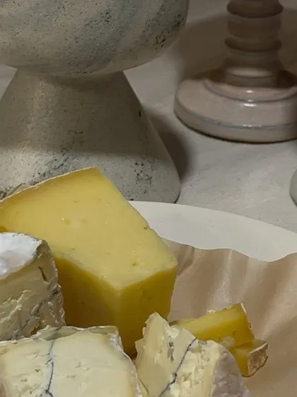 A cheese plate next to our custom goblets. The collection was designed to stimulate all the senses and elevate the experience of savoring food and wine.