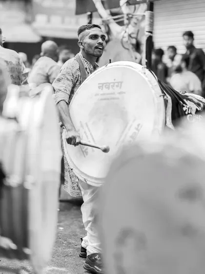 The black and white version, highlighting the drummer's dynamic pose.