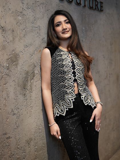 A client embodying effortless elegance in the embellished waistcoat and sequin pants, a perfect fusion of traditional embellishment and contemporary sparkle.