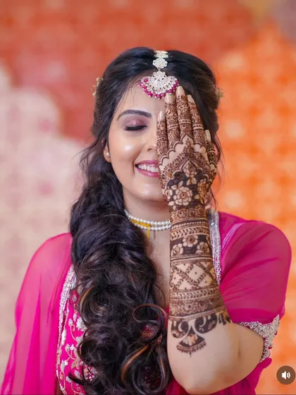 The smile on a client's face is the most rewarding part of my work. This beautiful shot captures the joy of wearing intricate floral and jaali patterned mehndi, ready for a wedding celebration.